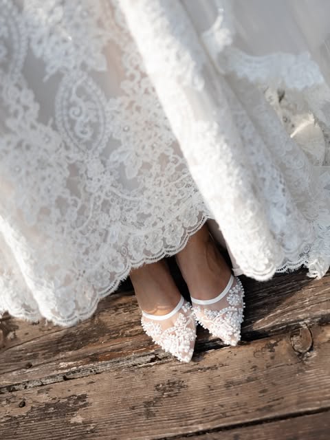 Lace bridal fabric and embellished wedding shoes