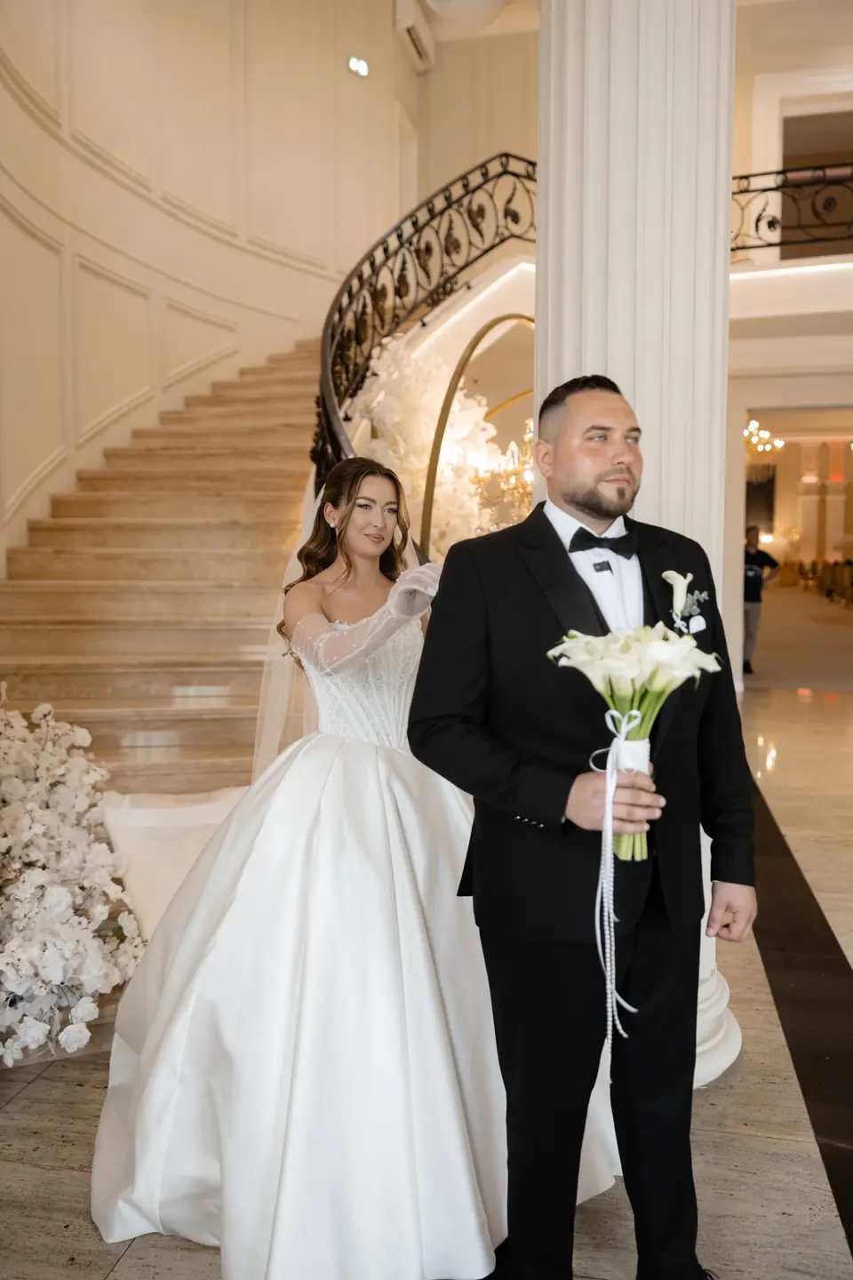 Alexandra and Norbert at the foot of a sweeping marble staircase