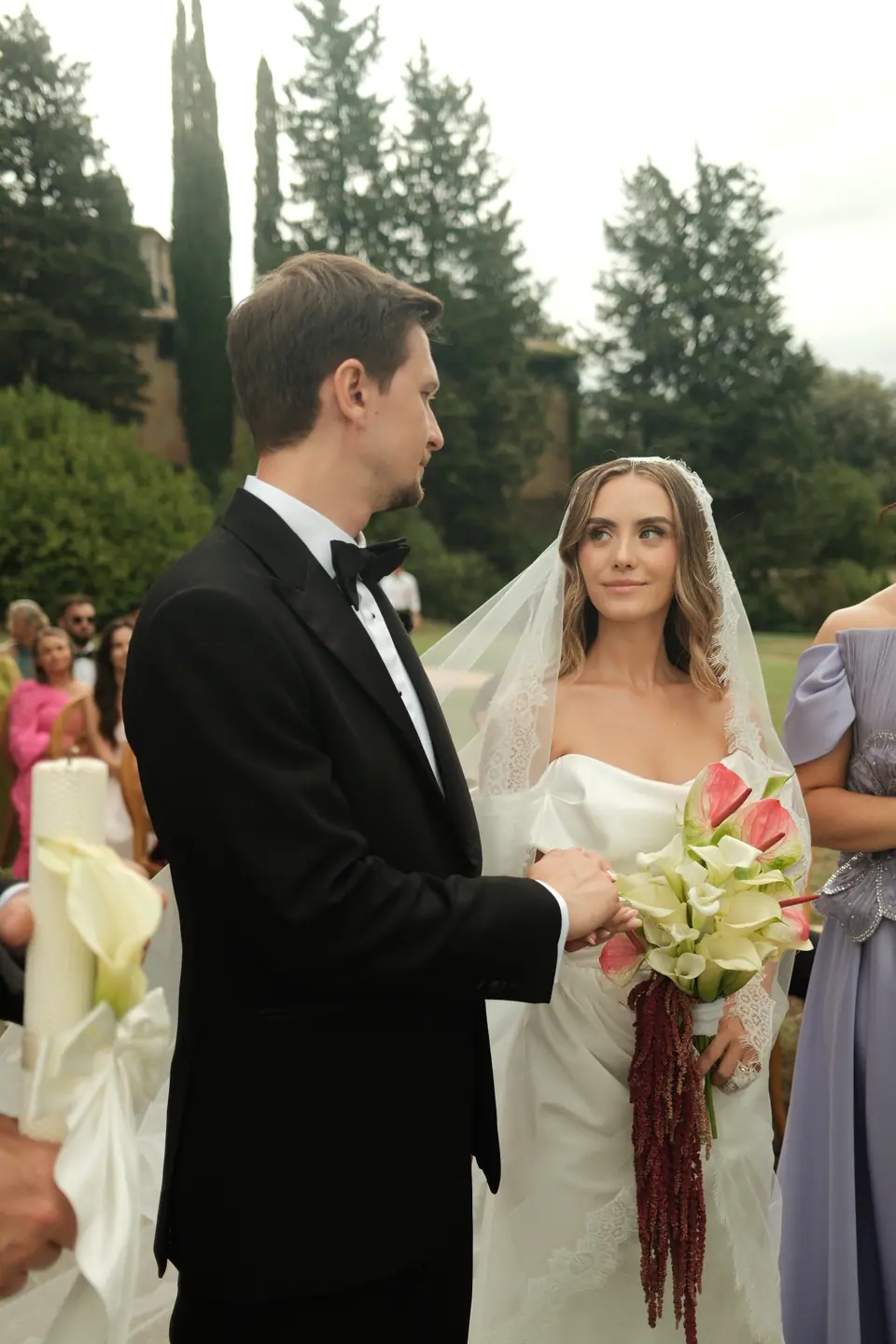 Silviu and Ana side by side at the ceremony, her bouquet of calla lilies