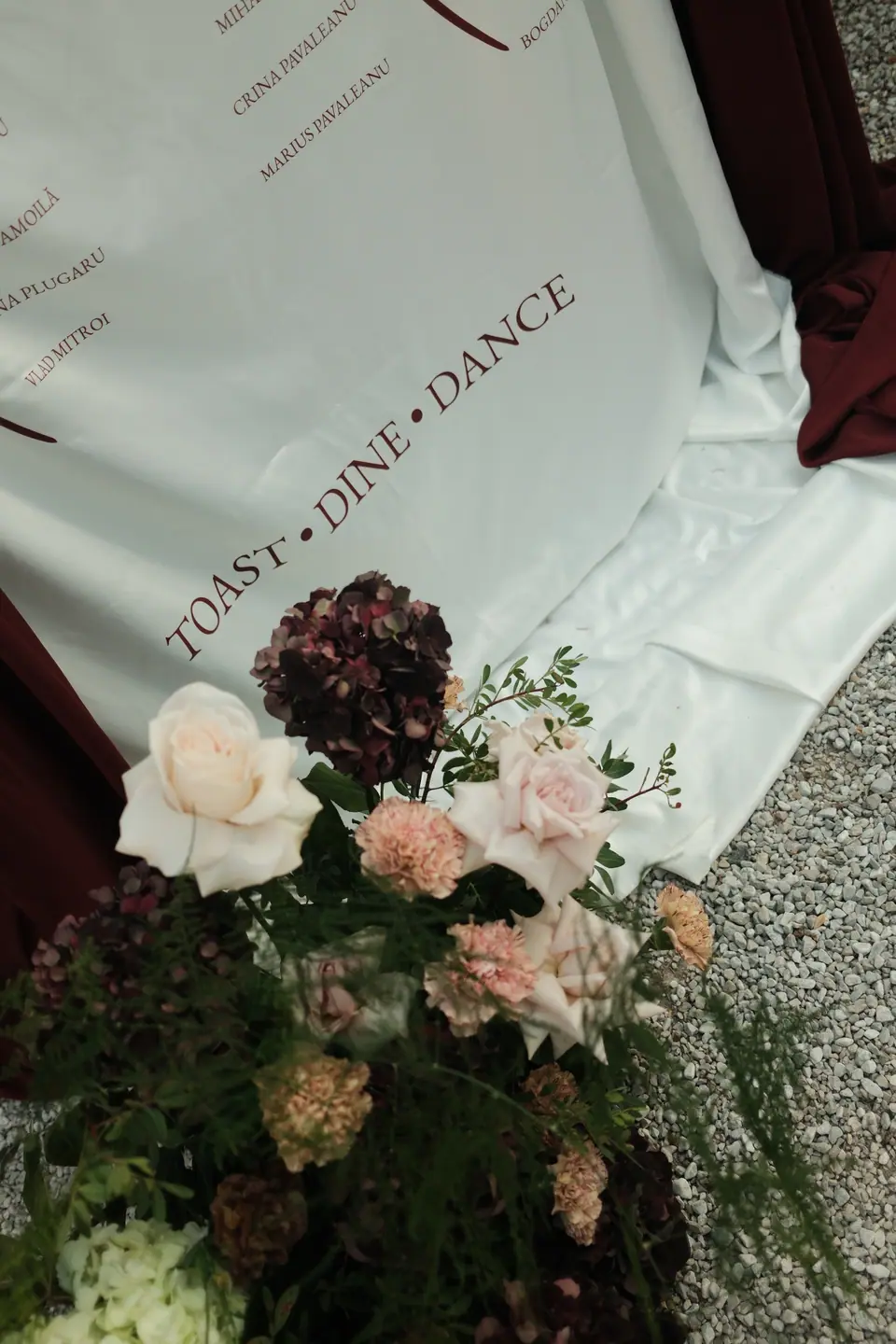 Flowers at the foot of the seating chart, printed “Toast · Dine · Dance”