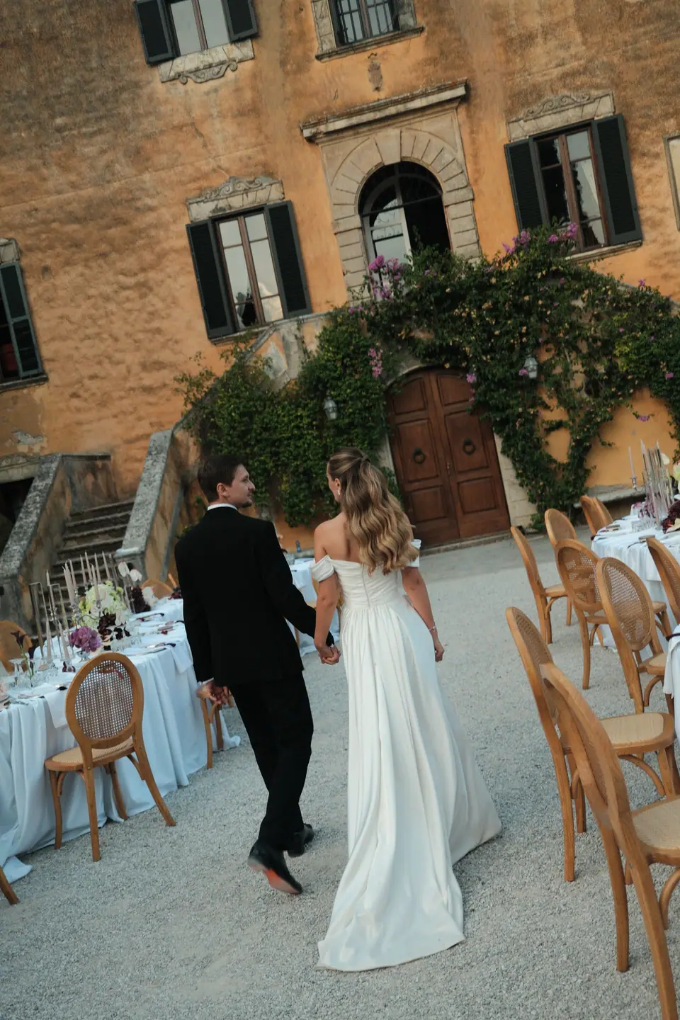 Ana and Silviu walking towards the villa door past the tables