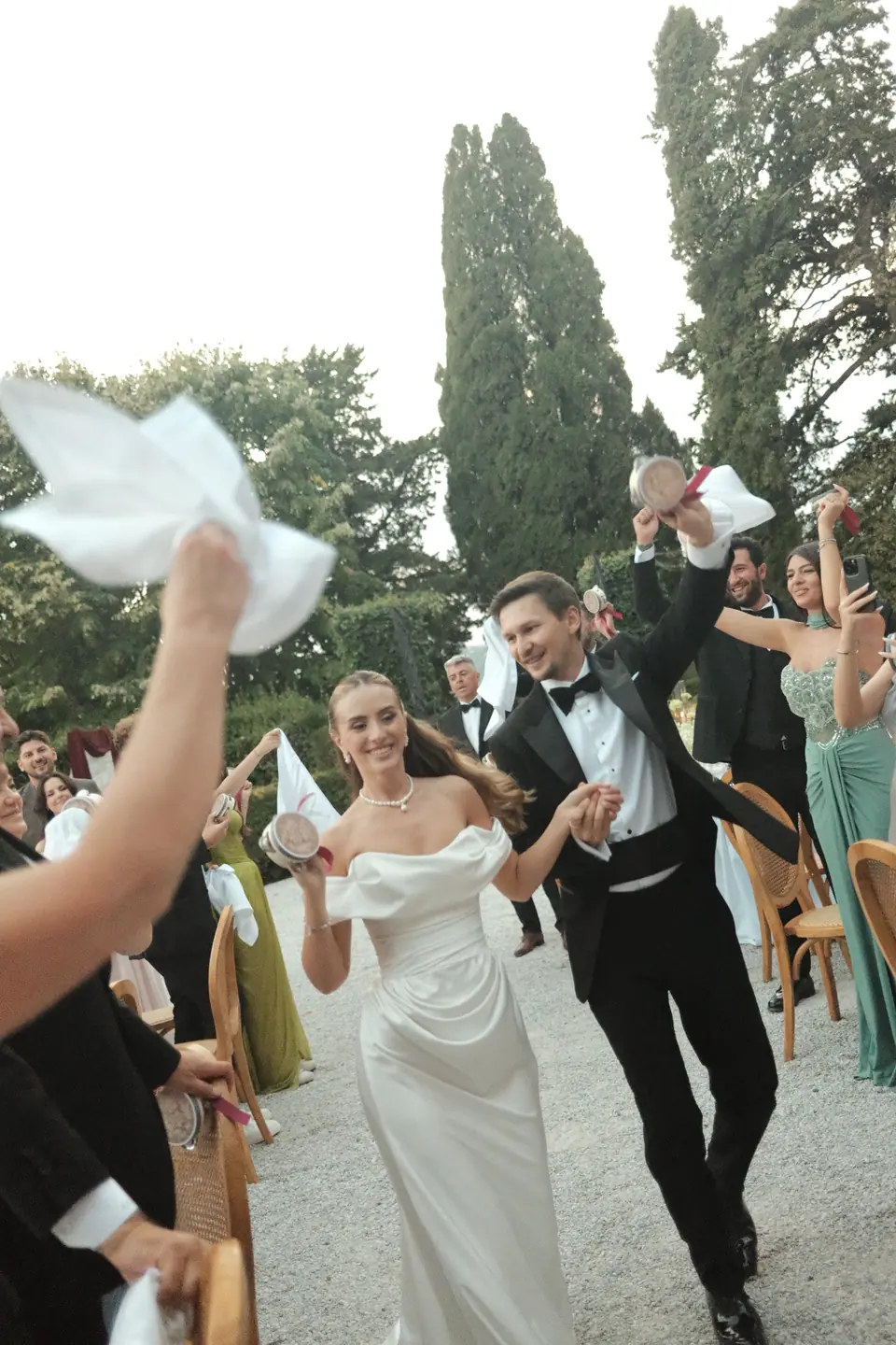 Ana and Silviu laughing as they dance through the waving guests