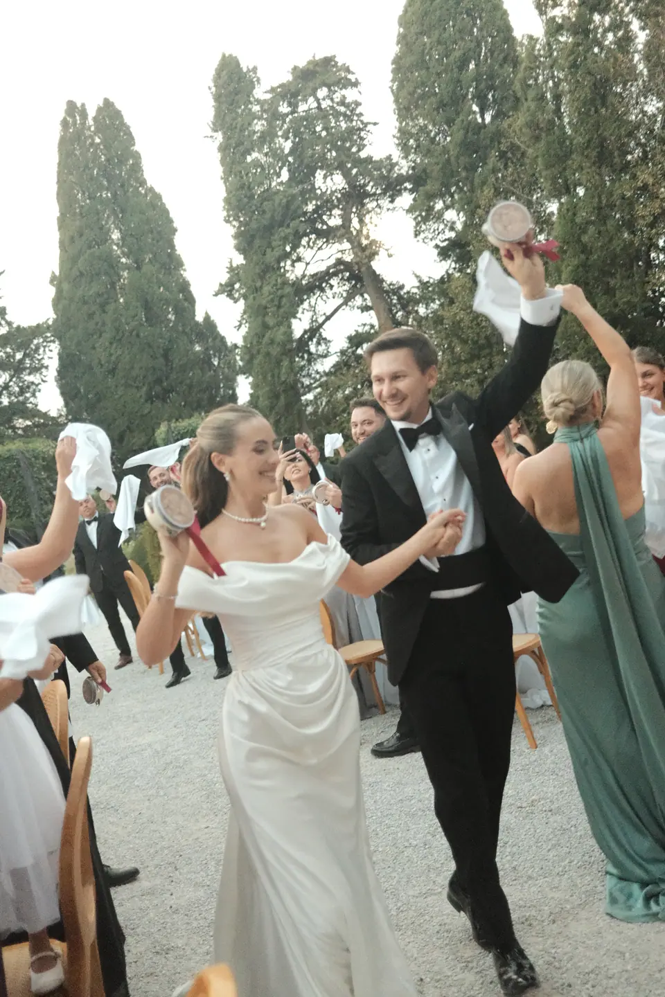 Silviu raising his arm as he and Ana dance into dinner