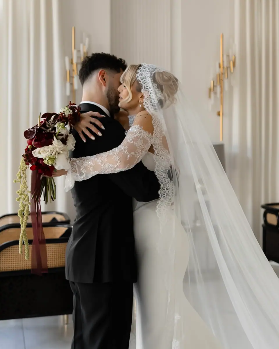 Bogdan holding Andreea close as her veil falls around them