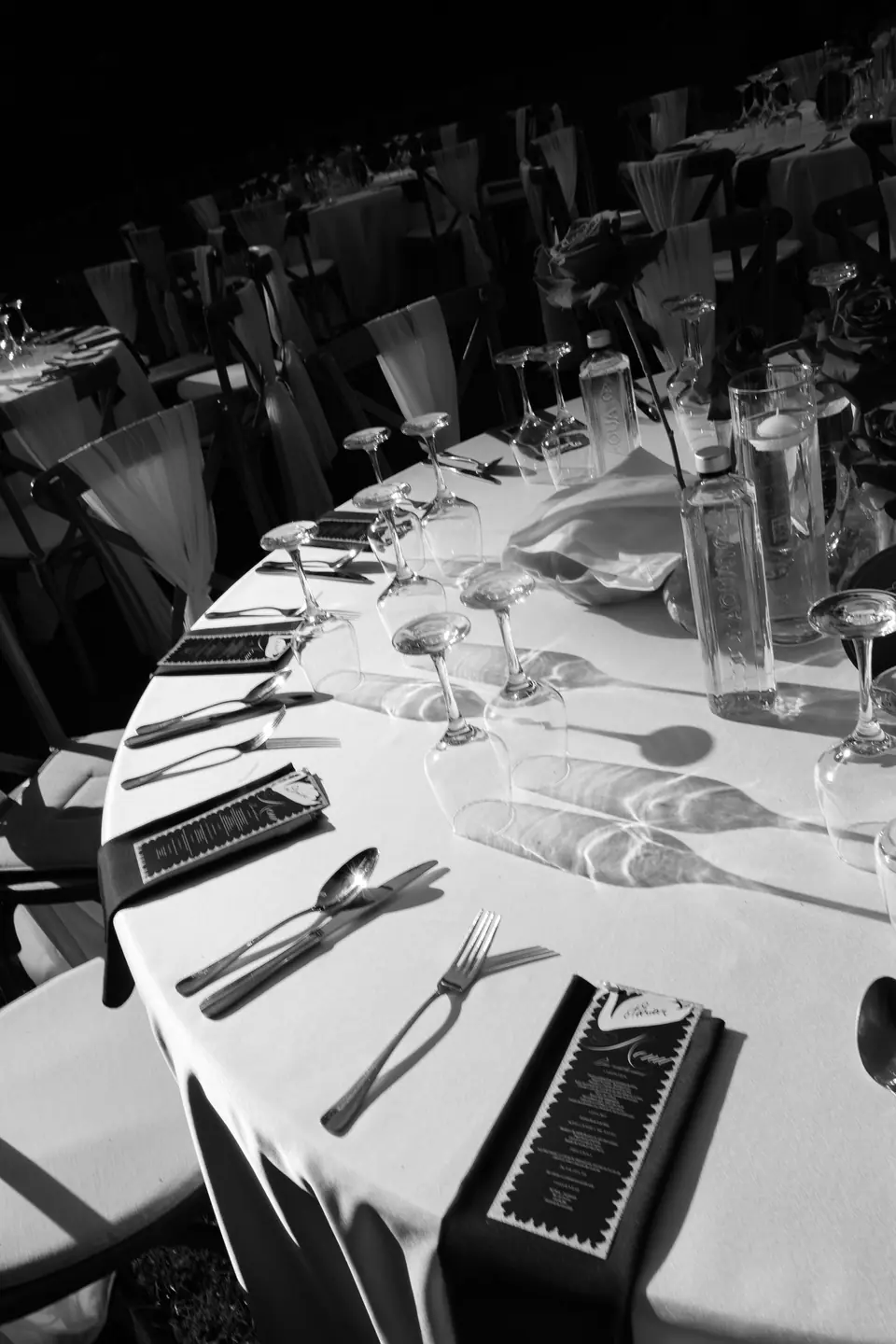 Black and white photograph of a round table set for dinner