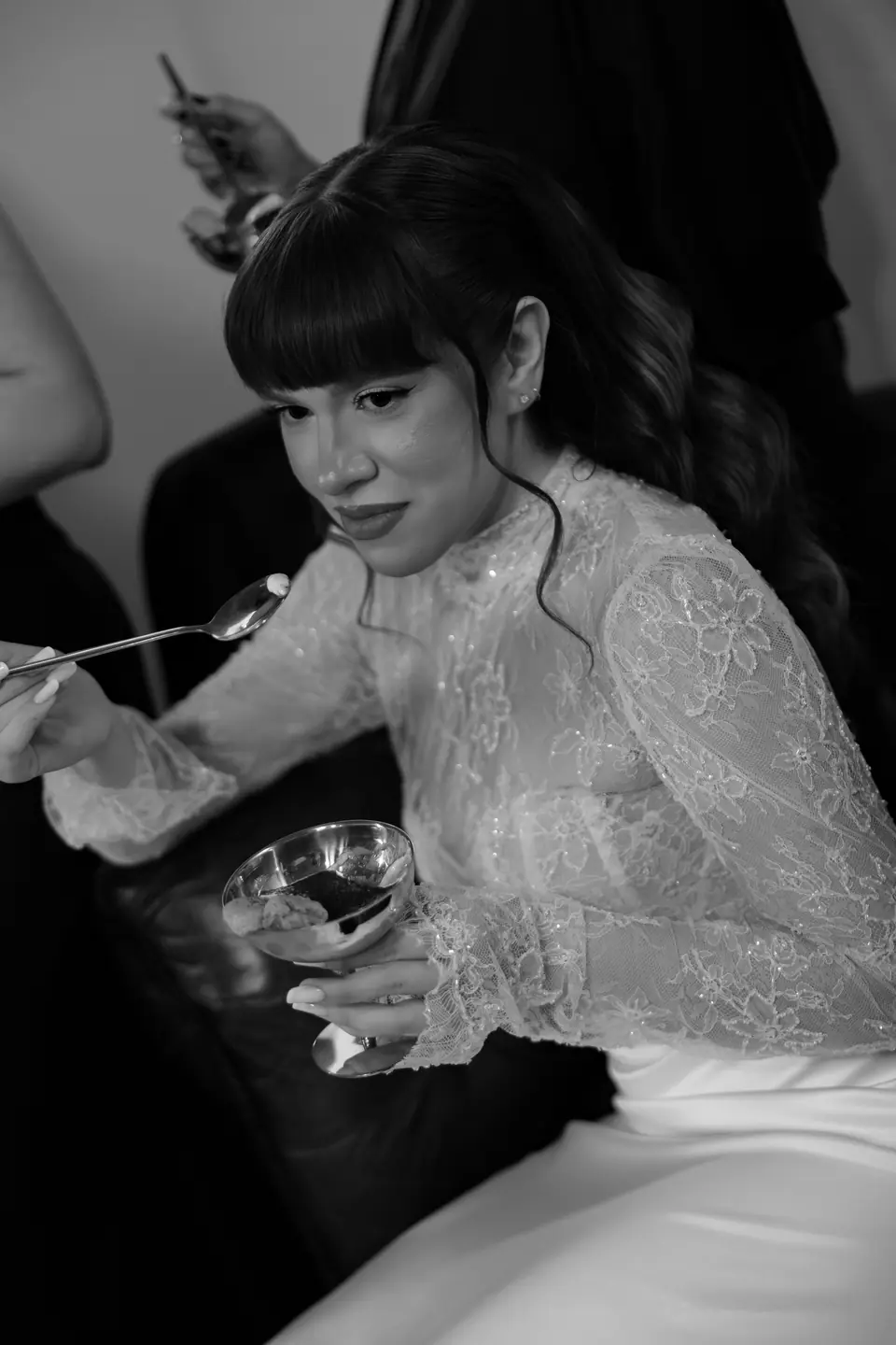 Black and white photograph of Bianca lifting a spoonful of tiramisu