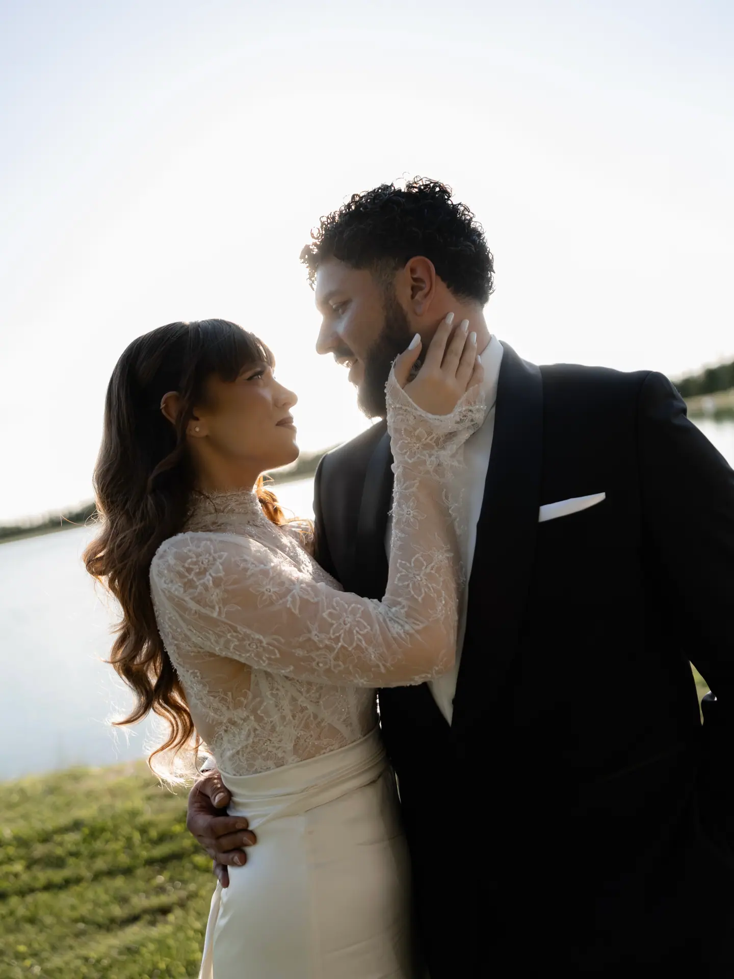 Bianca and Bogdan holding each other beside a lake in evening light