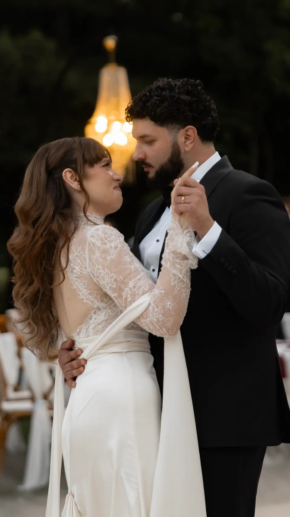 Bianca and Bogdan dancing beneath a chandelier at night