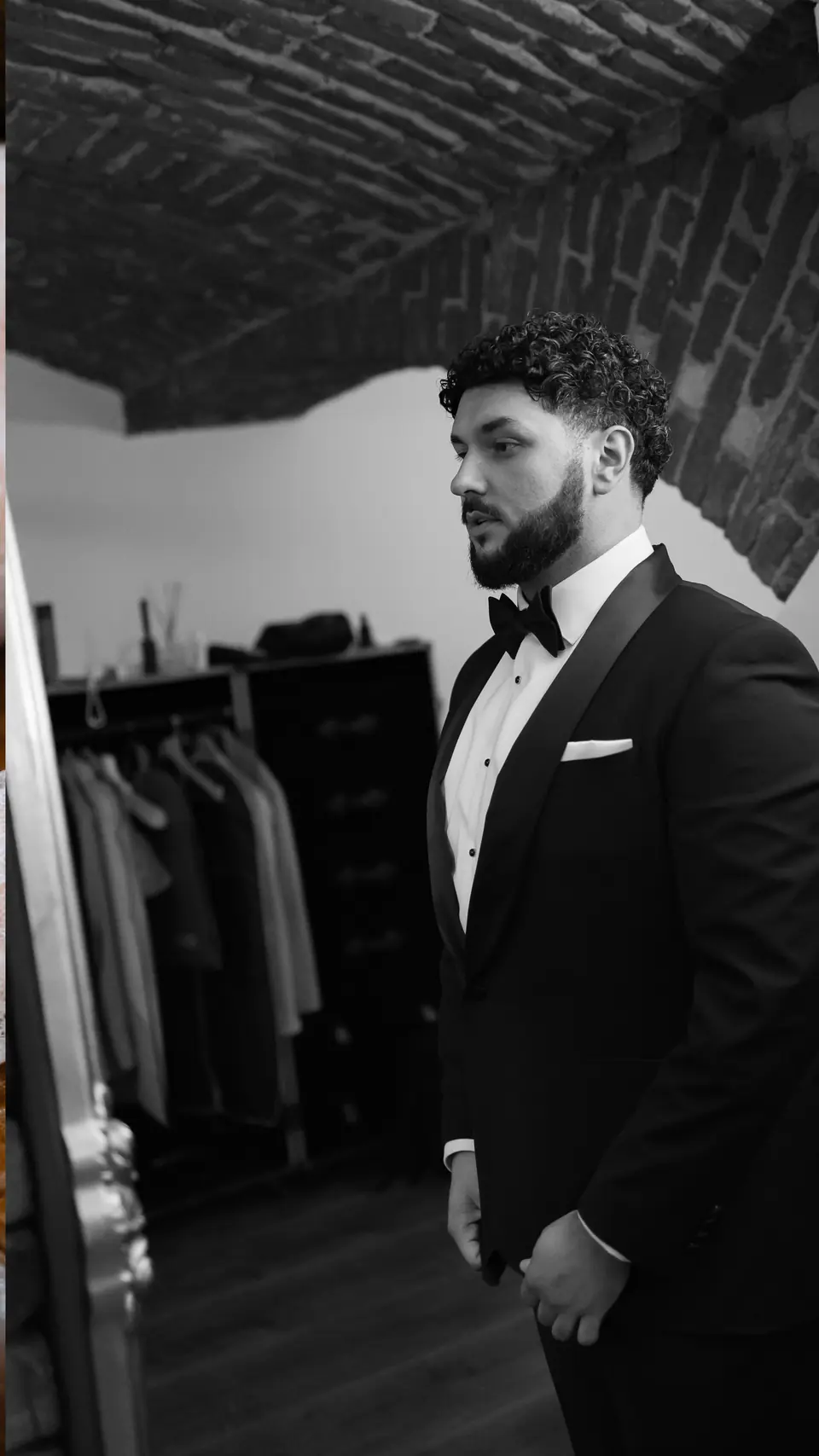 Black and white photograph of Bogdan in his tuxedo in a dressing room