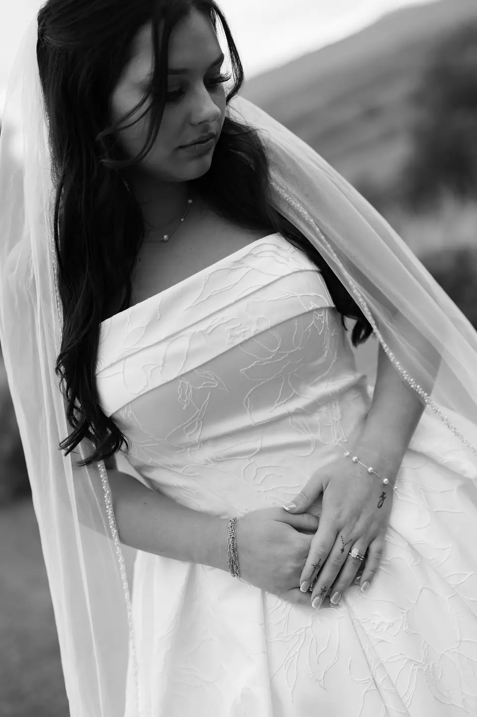 Black and white portrait of Haley in her veil, hands folded at her waist