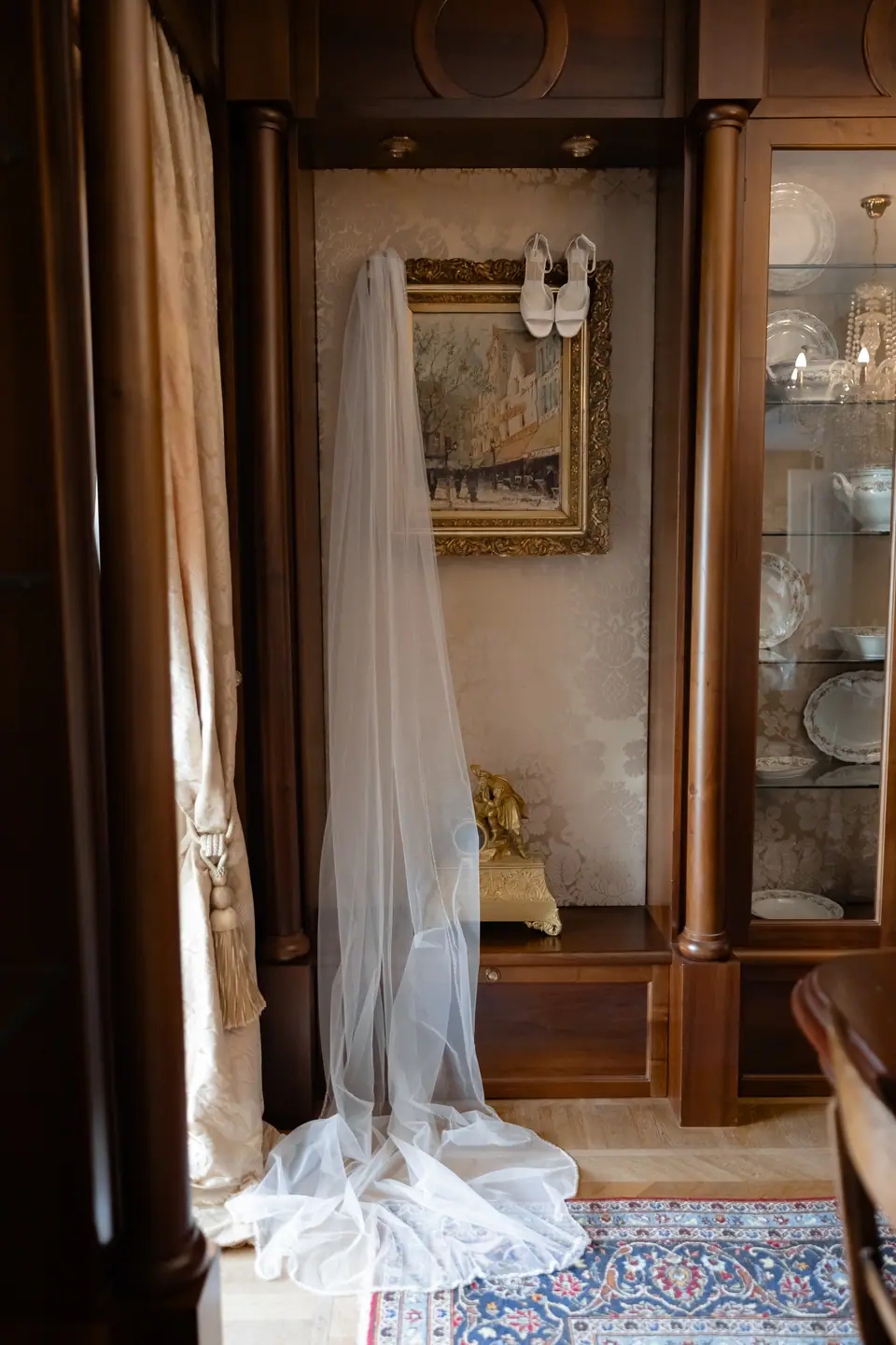 Haley’s long veil hanging in a wood-panelled room, her shoes on the shelf above