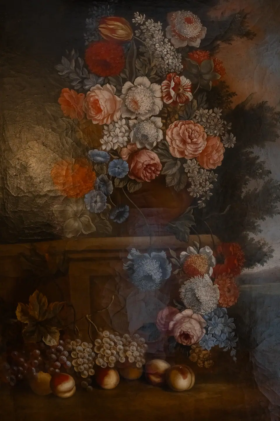 An old still-life painting of roses and peaches on the villa wall