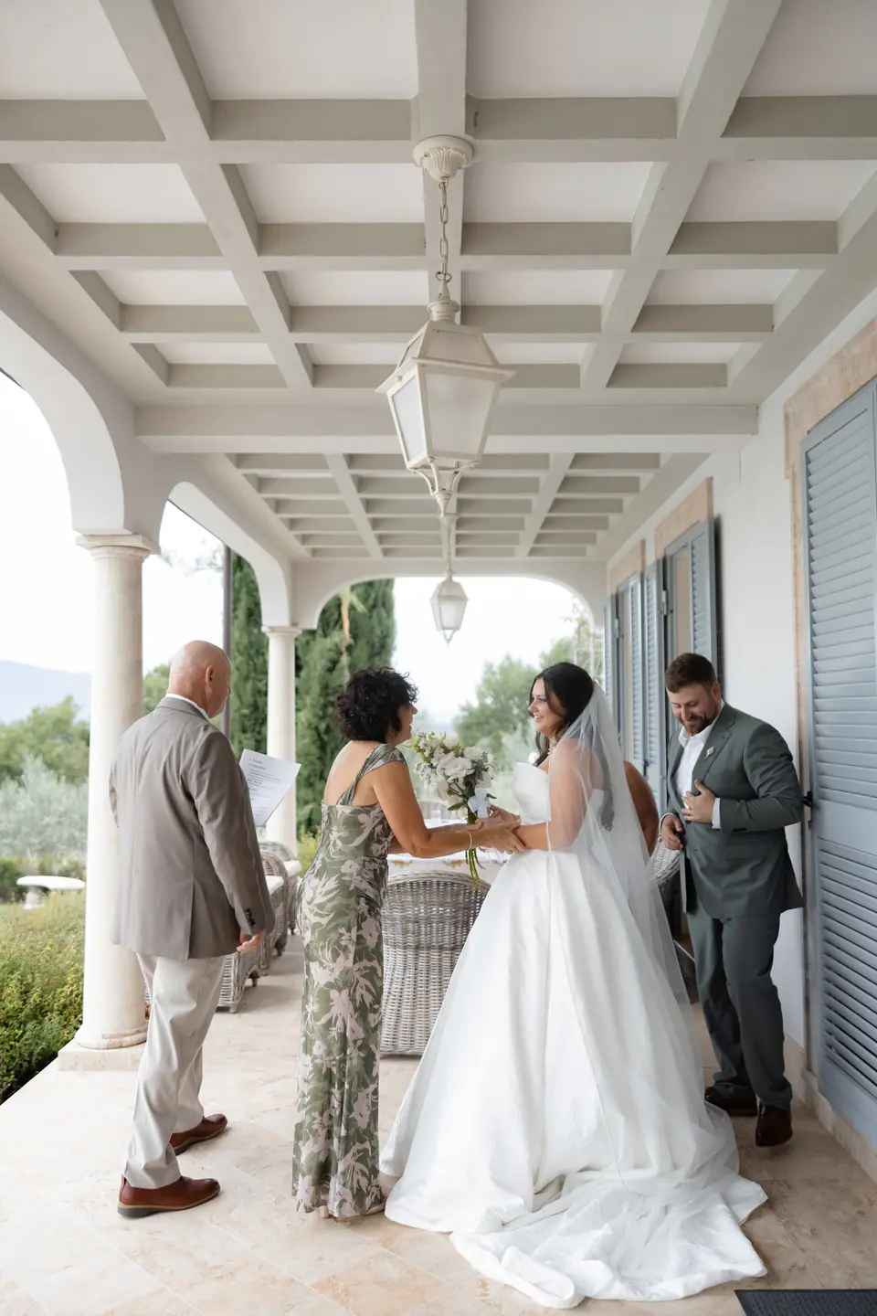 Their families greeting Haley and Zach under the villa’s covered terrace