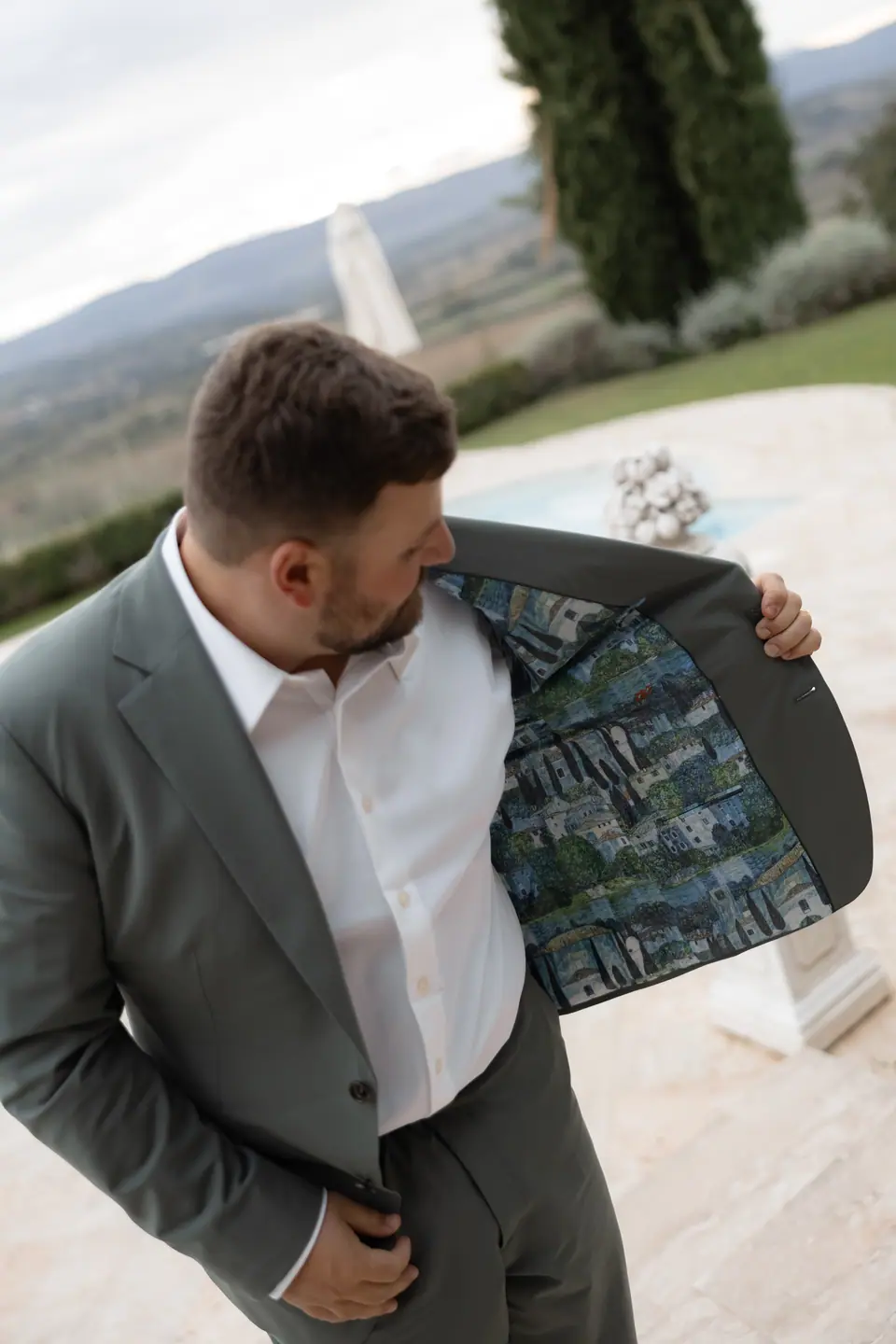 Zach opening his sage jacket to show its painted lining
