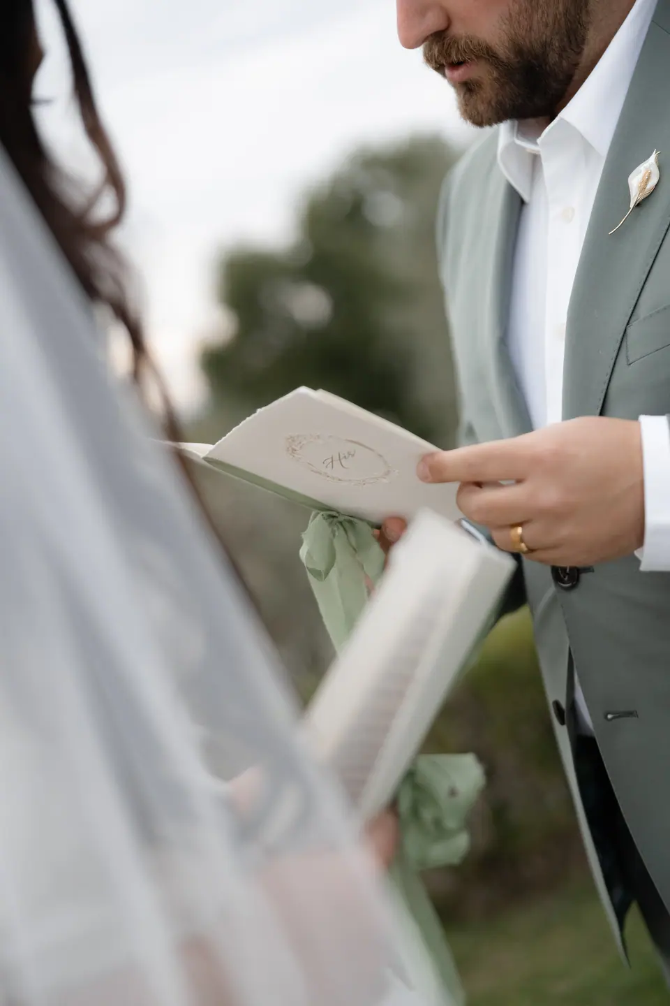 Zach reading a letter tied with green ribbon to Haley