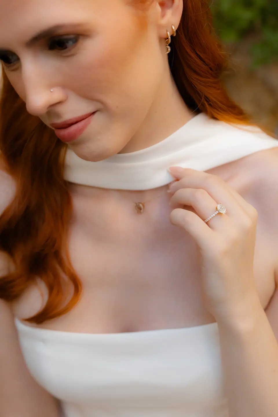Kate in a white scarf, her engagement ring catching the light
