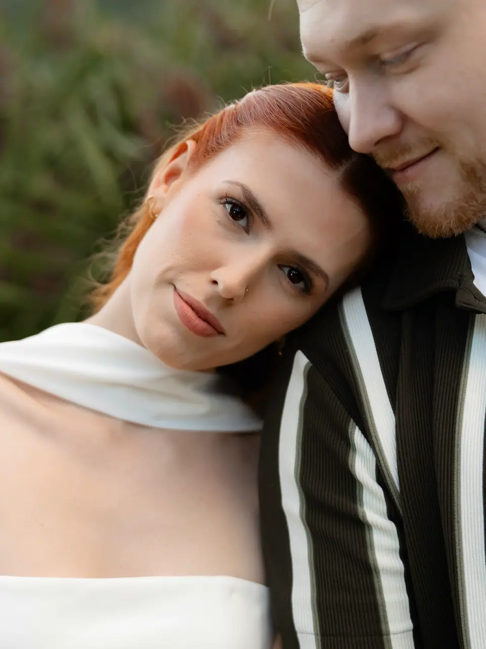 Kate leaning her head on James’s shoulder, looking into the camera