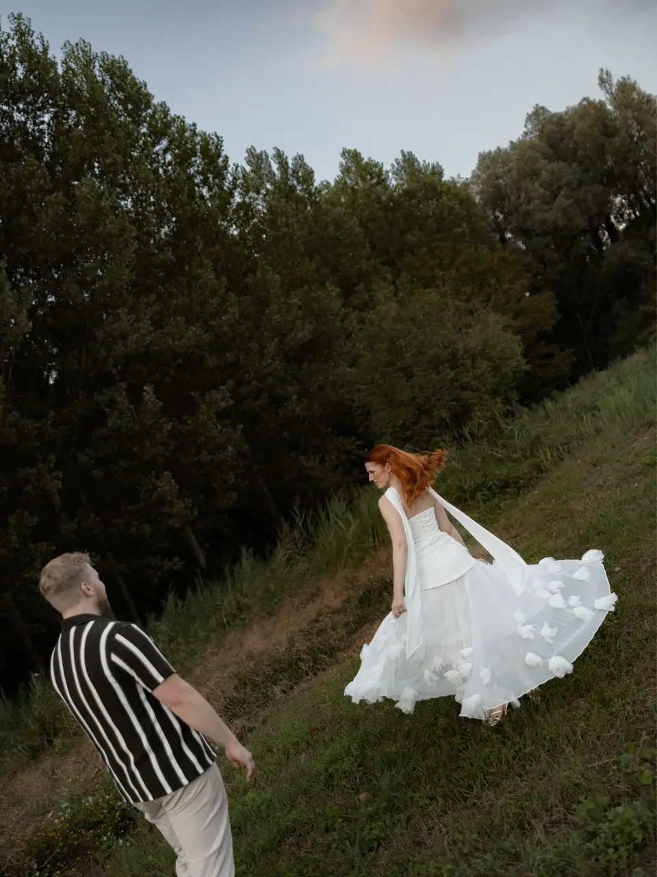 James watching Kate’s dress swirl as she walks across a grassy hillside