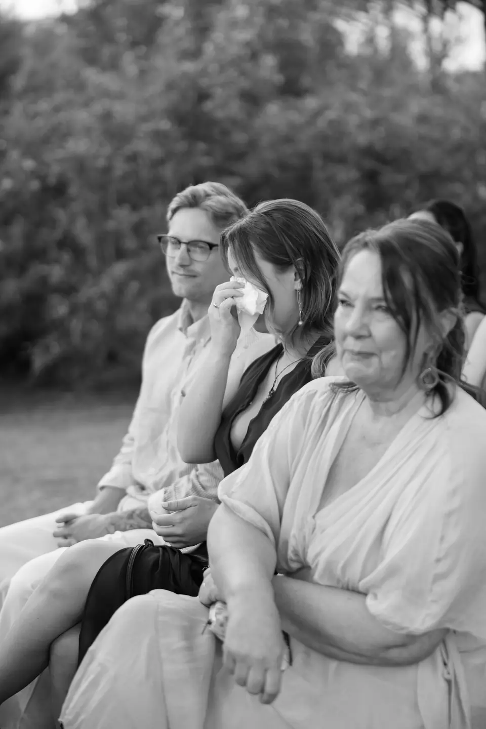Black and white photograph of guests in tears during the ceremony