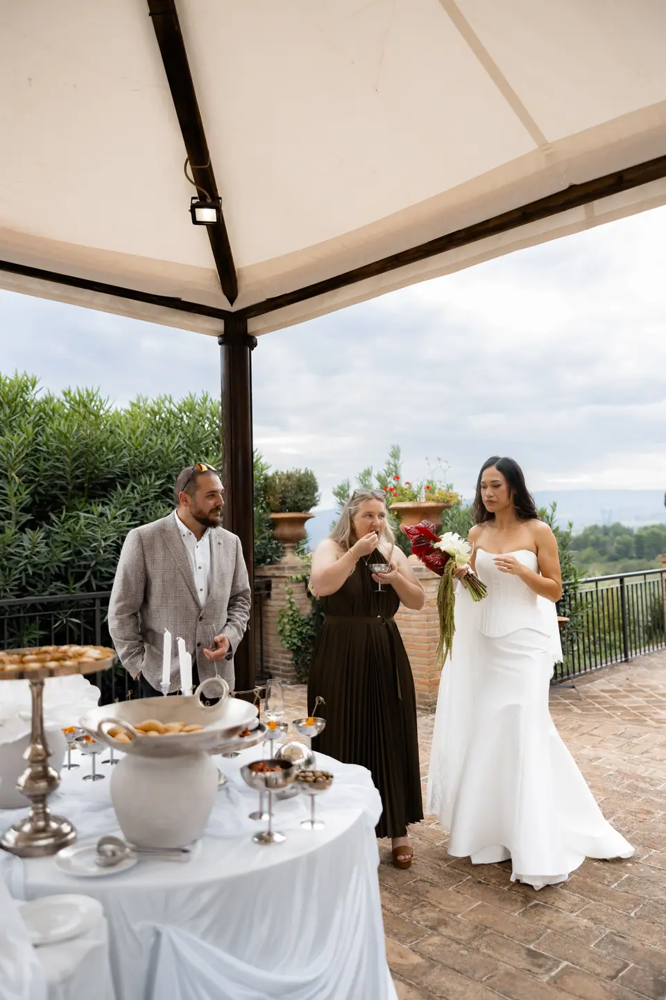 Sivitha and Rory sharing aperitivo under the white pavilion
