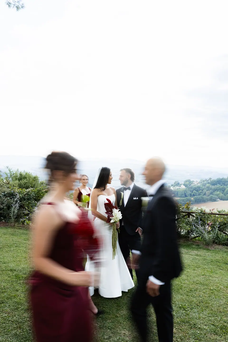 The bridal party moving past in a blur on the lawn
