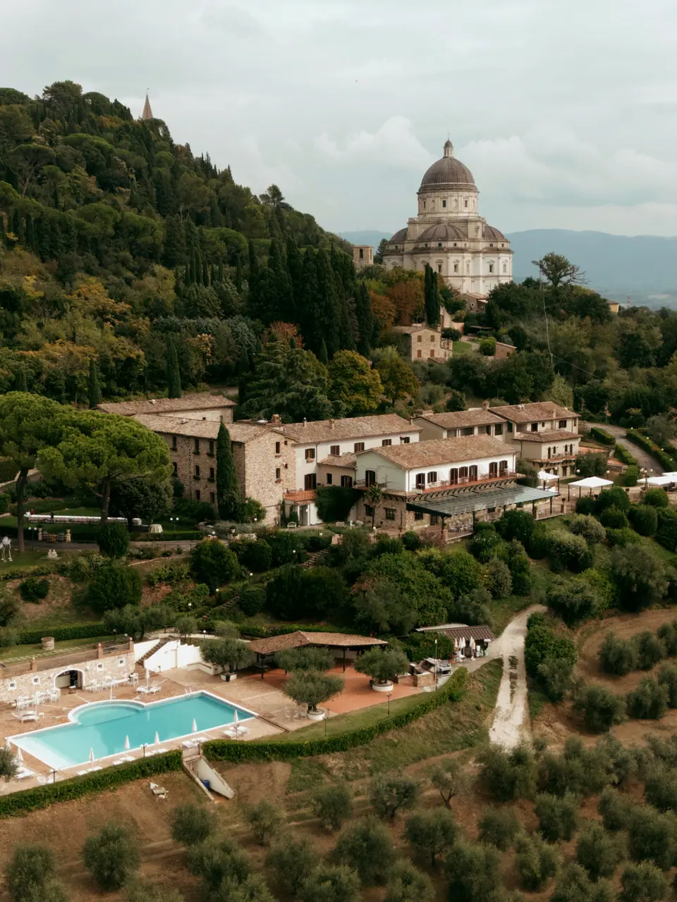Aerial view of Monastero Santa Margherita and its pool, a domed church on the hill above