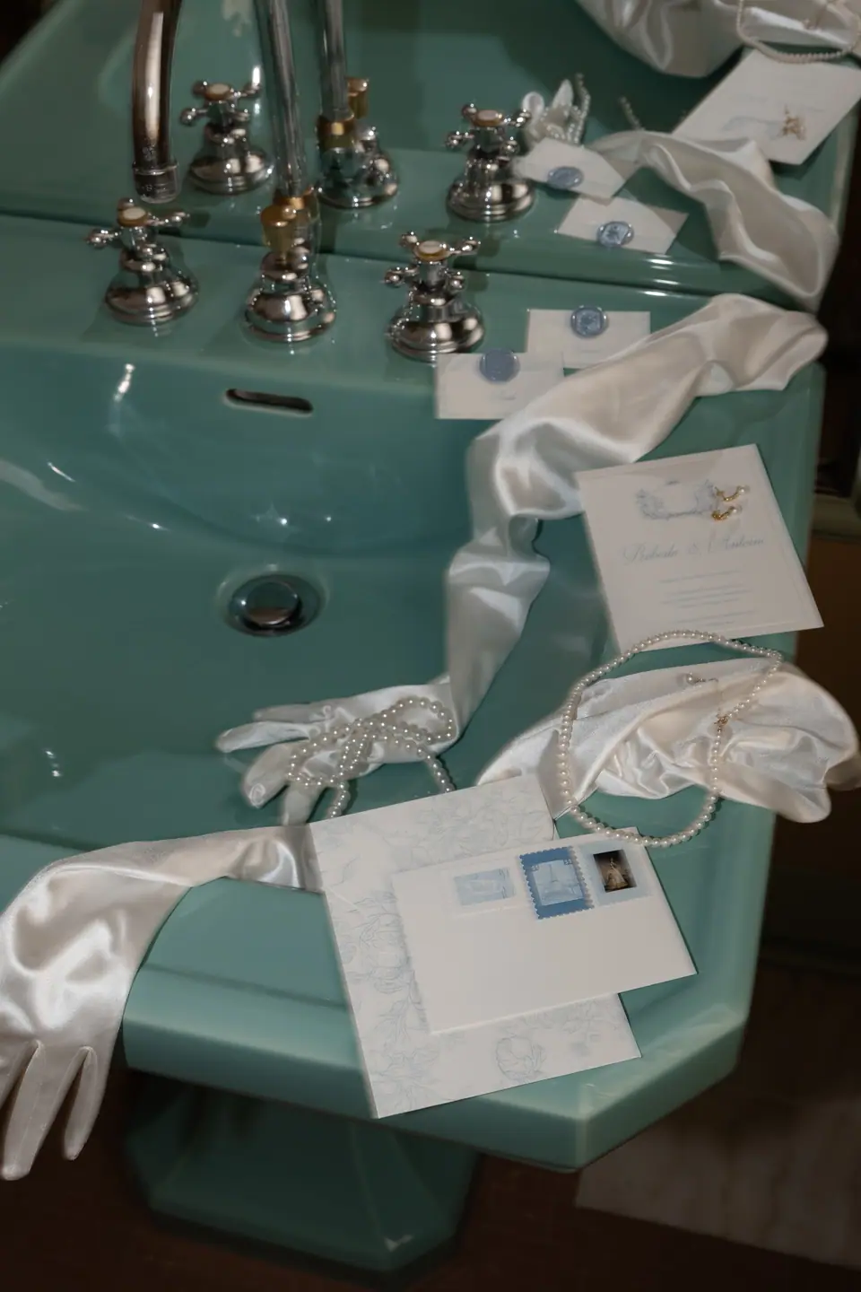 Bridal sink in pale green with satin gloves, pearls, shoes and wax-sealed stationery