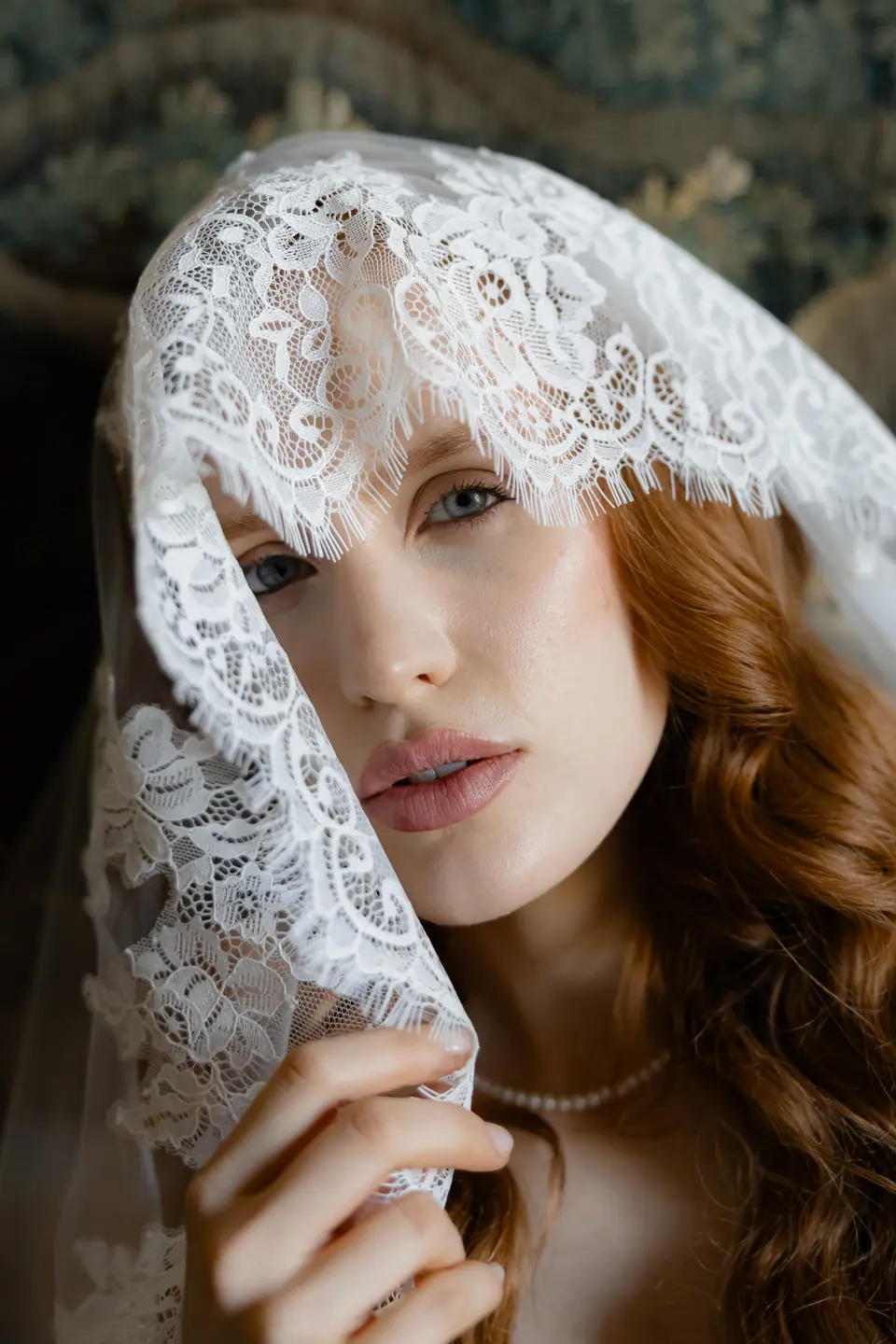 Roberta’s face half covered by a lace veil, a pearl necklace at her throat